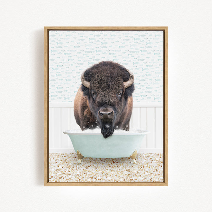 A buffalo with a black mane and horns is standing in a white bathtub filled with water, looking directly at the camera.