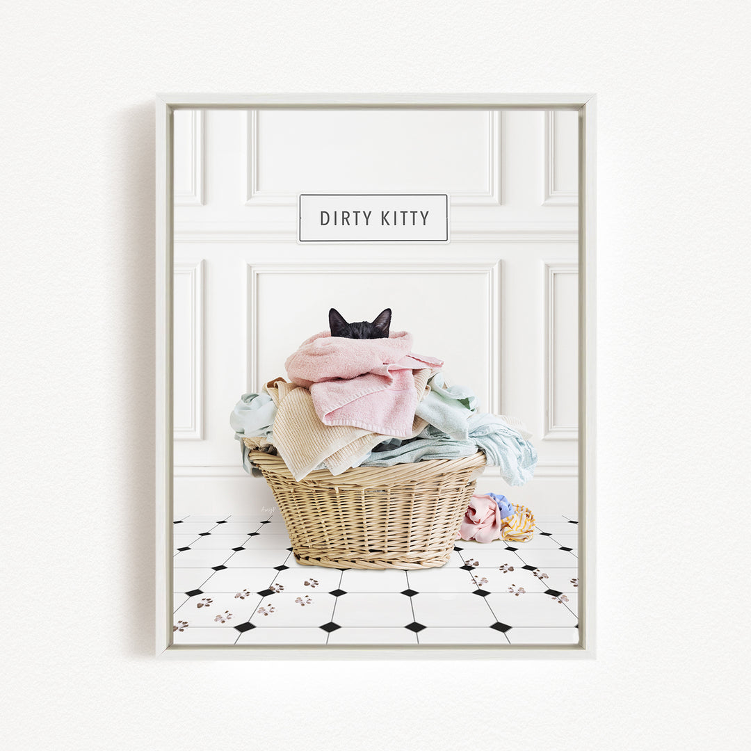 A framed image depicting a cat sitting in a basket filled with laundry, with the text "Dirty Kitty" above the basket.