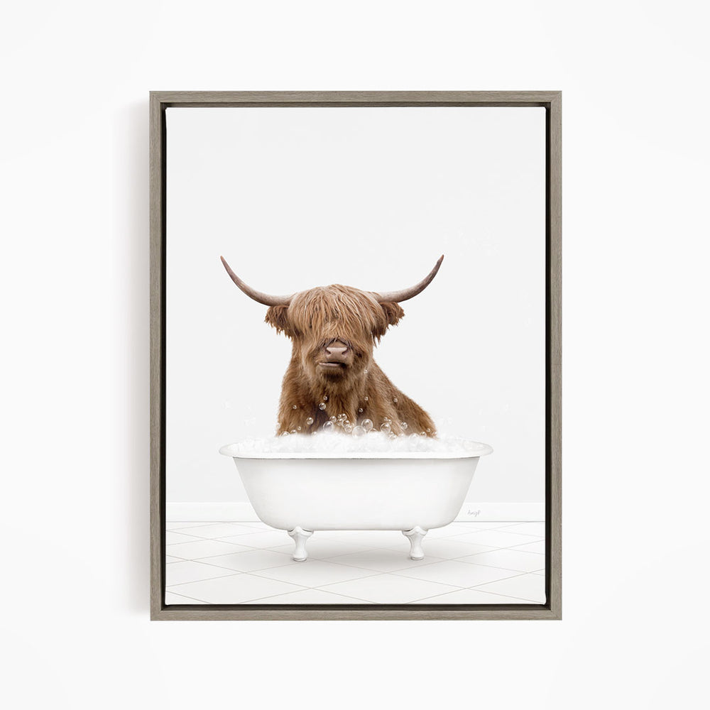 A brown cow with long horns is sitting in a white bathtub filled with water, appearing to enjoy the bath.