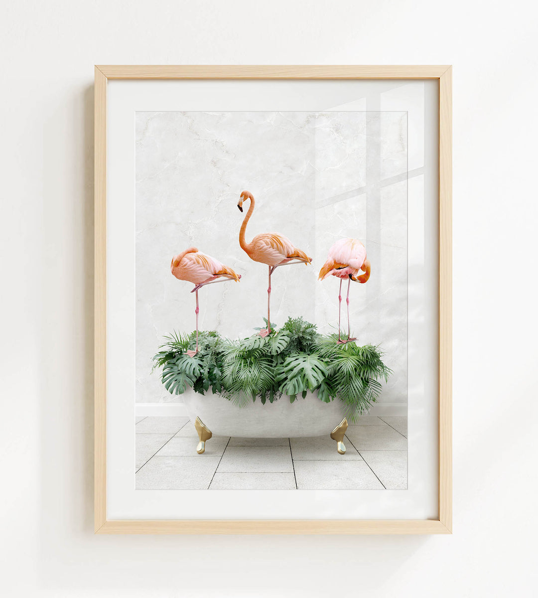 A framed image of three flamingos standing on a bathtub filled with green plants.