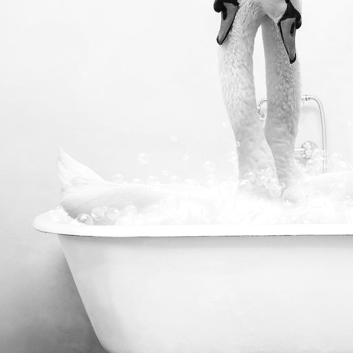 a white swan is taking a bath in a bathtub