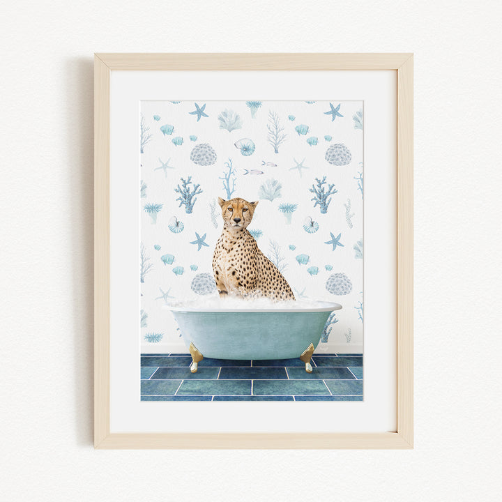 A cheetah sitting in a bathtub filled with water, surrounded by a blue and white ocean-themed wallpaper.