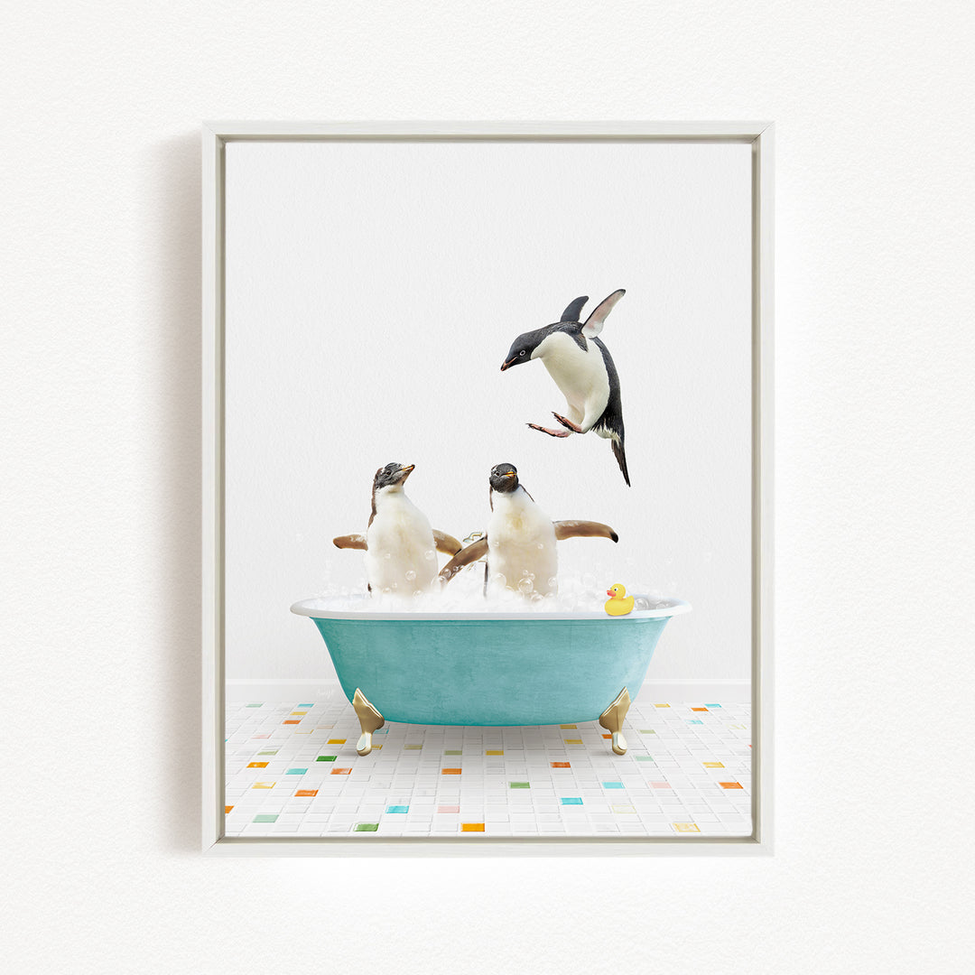 A framed image depicting two penguins sitting in a bathtub, with one penguin jumping out of the tub and another penguin sitting in the tub.