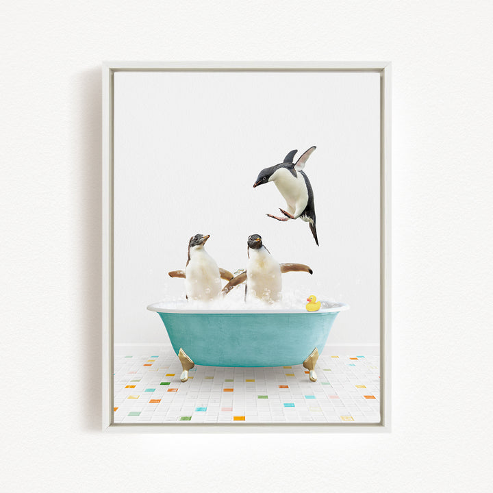 A framed image depicting two penguins sitting in a bathtub, with one penguin jumping out of the tub and another penguin sitting in the tub.