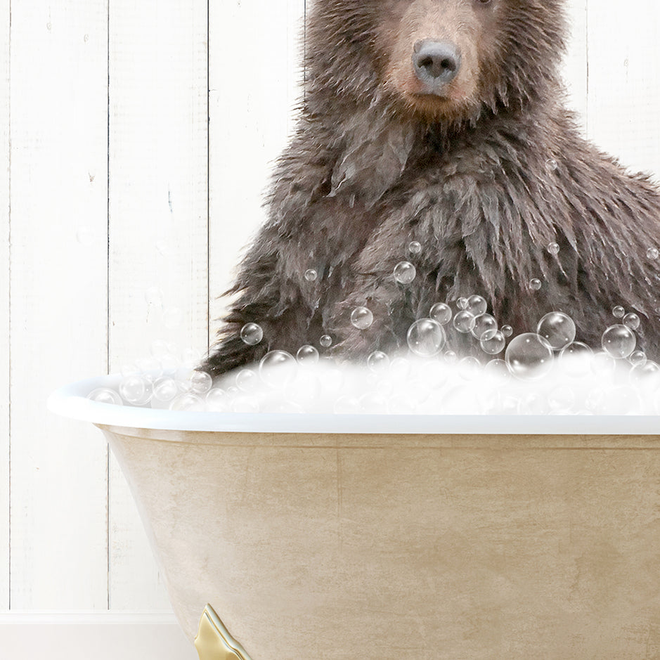 a brown bear sitting in a bathtub filled with bubbles