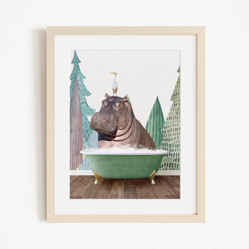 A framed image depicting a hippopotamus sitting in a green bathtub, with a seagull perched on its head.