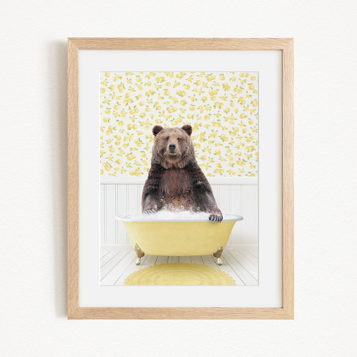 A brown bear sitting in a yellow bathtub, surrounded by a yellow floral pattern on the wall behind it.