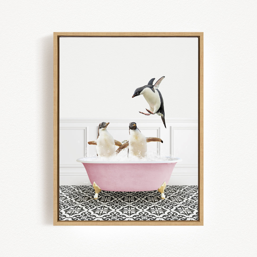 A framed image depicting two penguins sitting in a pink bathtub, with one penguin jumping out of the tub.