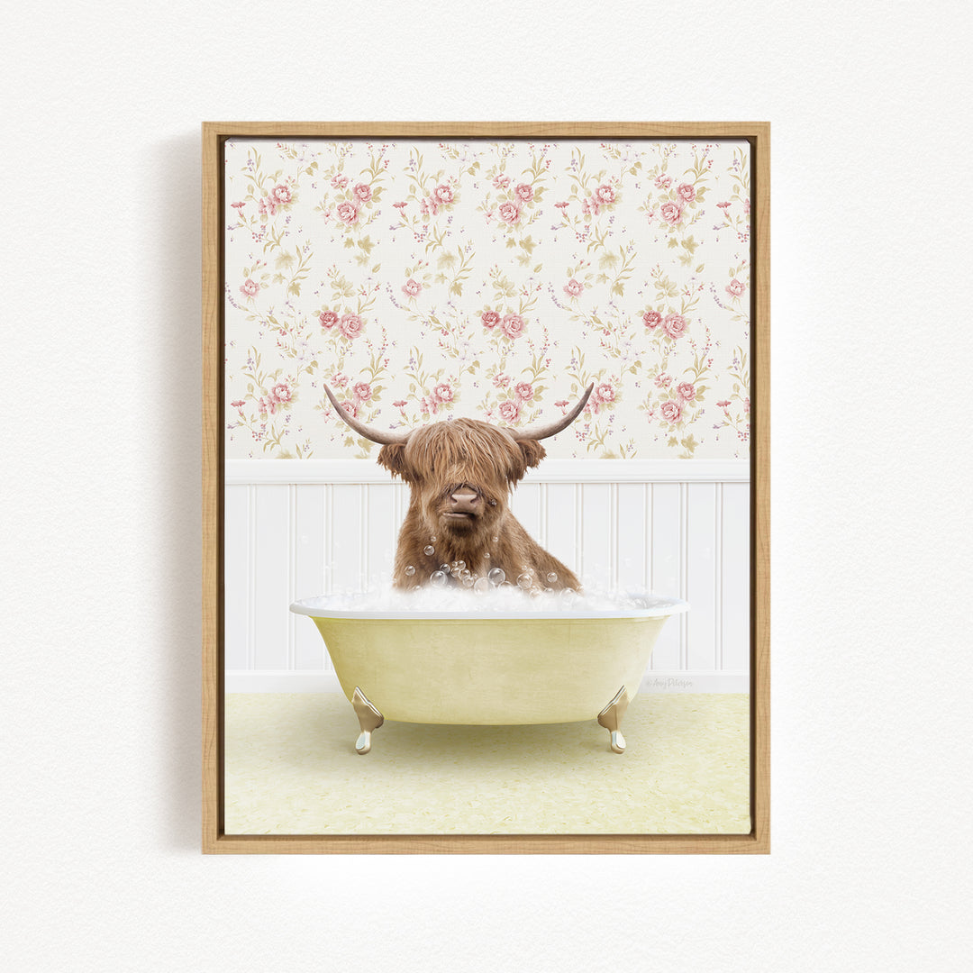 A brown cow with long horns is sitting in a white bathtub filled with bubbles, against a floral wallpaper background.