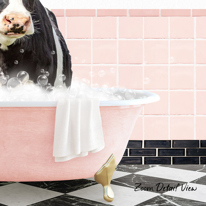 A black and white cow is sitting in a pink bathtub filled with bubbles, with a towel hanging on the side and a pink tile wall in the background.