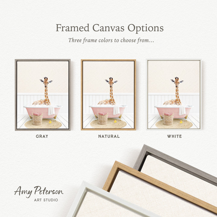 The image is a framed canvas option showcasing three different frame colors: gray, natural, and white. The canvas features a giraffe sitting in a pink bathtub, with a basket nearby.