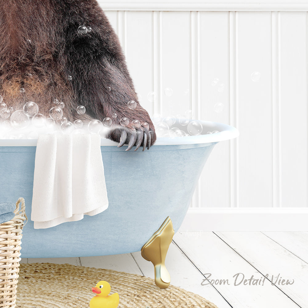 A brown bear is sitting in a blue bathtub filled with bubbles, with a yellow rubber duck nearby.