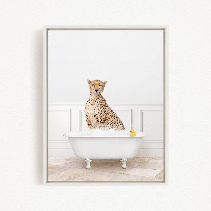 A cheetah sitting in a white bathtub filled with water, with a rubber duck floating in the water.