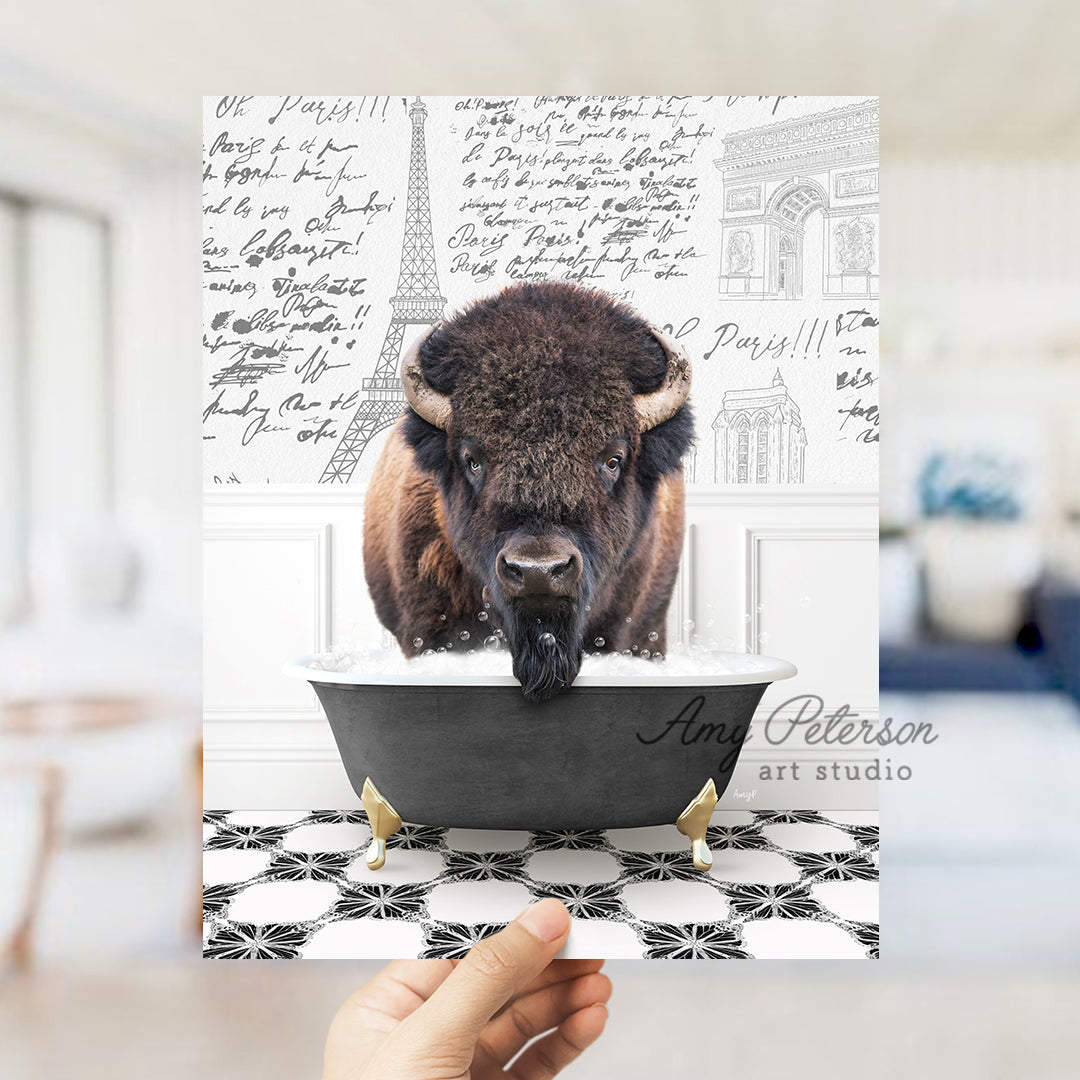 a person holding up a card with a picture of a bison in a bathtub