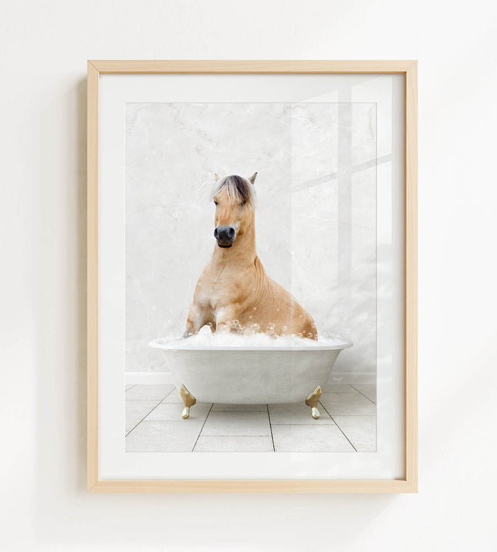 A light brown horse is sitting in a white bathtub filled with bubbles, creating a whimsical and playful scene.