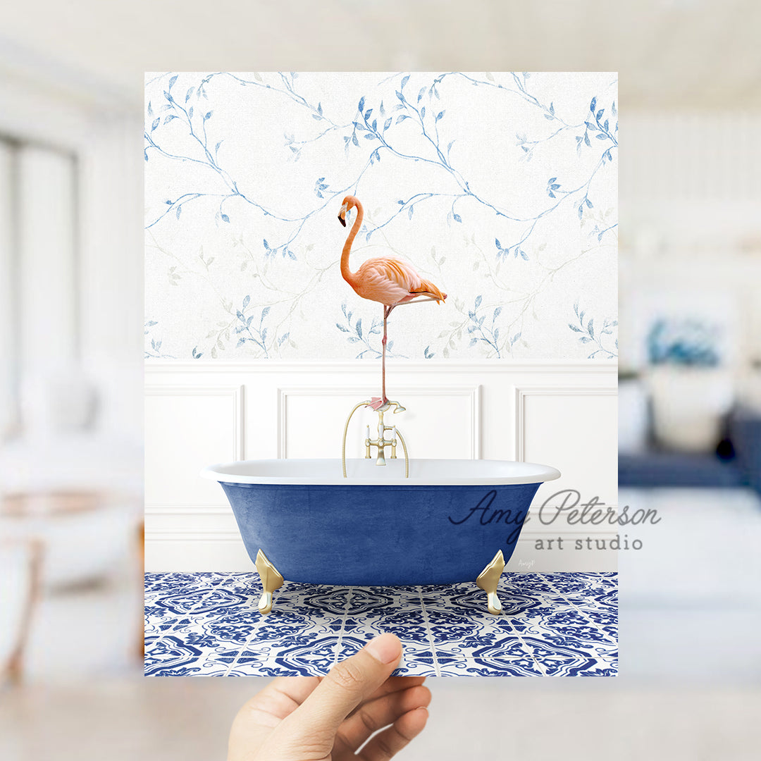 a person holding a card with a flamingo in a bathtub