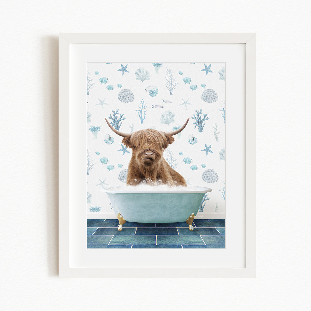 A brown cow with long horns is sitting in a blue bathtub filled with bubbles, surrounded by a blue and white seashell and starfish pattern on the wall behind it.