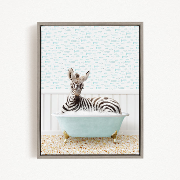 A zebra is sitting in a light blue bathtub, surrounded by a pattern of small fish.
