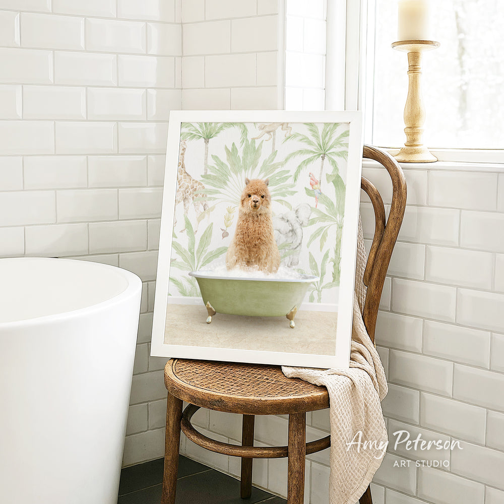 A framed image of a brown dog sitting in a green bathtub, surrounded by tropical foliage, is displayed on a wooden chair in a bathroom setting.