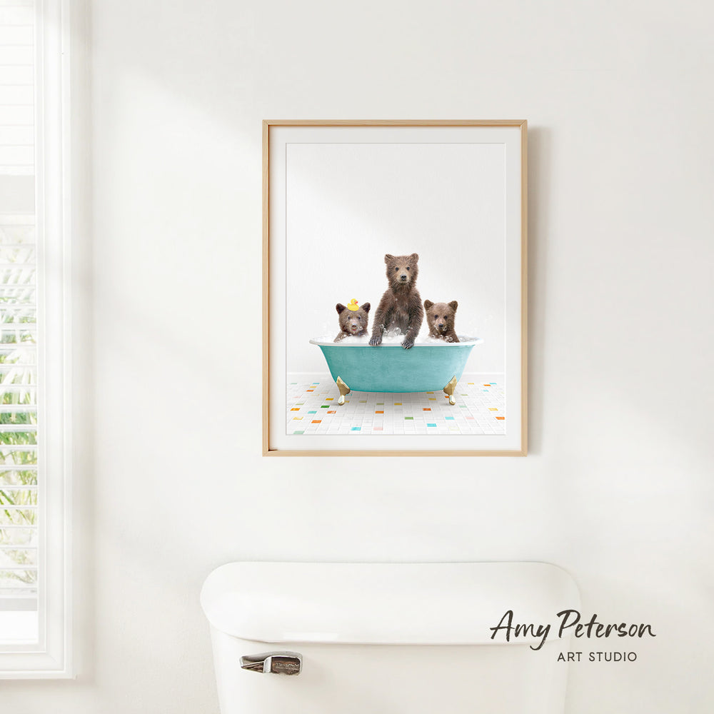 A framed image of three bears sitting in a bathtub, with one bear standing on its hind legs and the other two sitting comfortably.