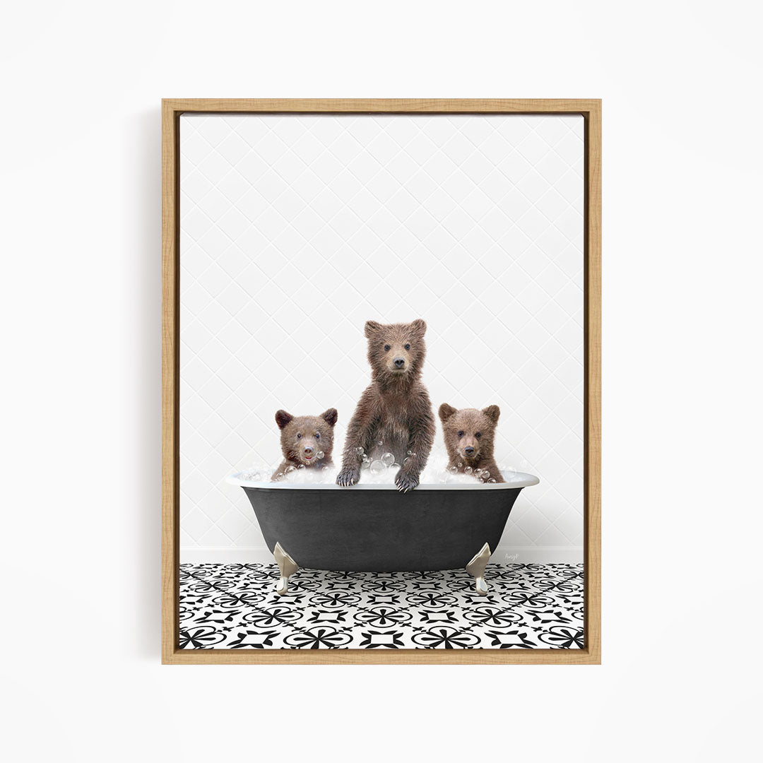 A framed image depicting three brown bears sitting in a bathtub filled with water, with a black and white patterned floor beneath them.