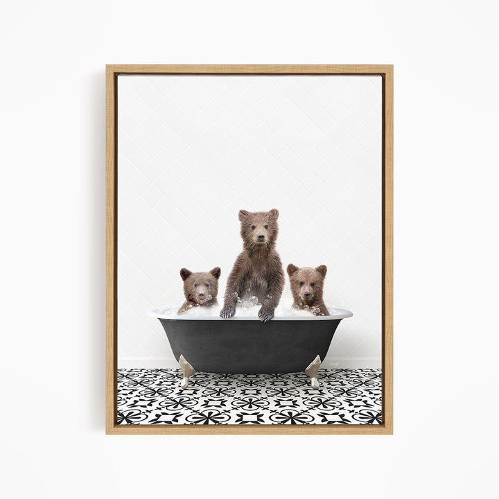 A framed image depicting three brown bears sitting in a bathtub filled with water, with a black and white patterned floor beneath them.