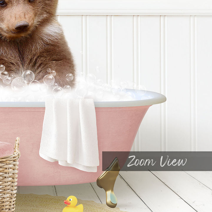 A cute brown bear is sitting in a pink bathtub filled with bubbles, surrounded by a yellow rubber duck and a white towel.