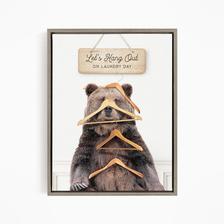 A framed image of a bear sitting in front of a sign that says "Let's Hang Out on laundry day".