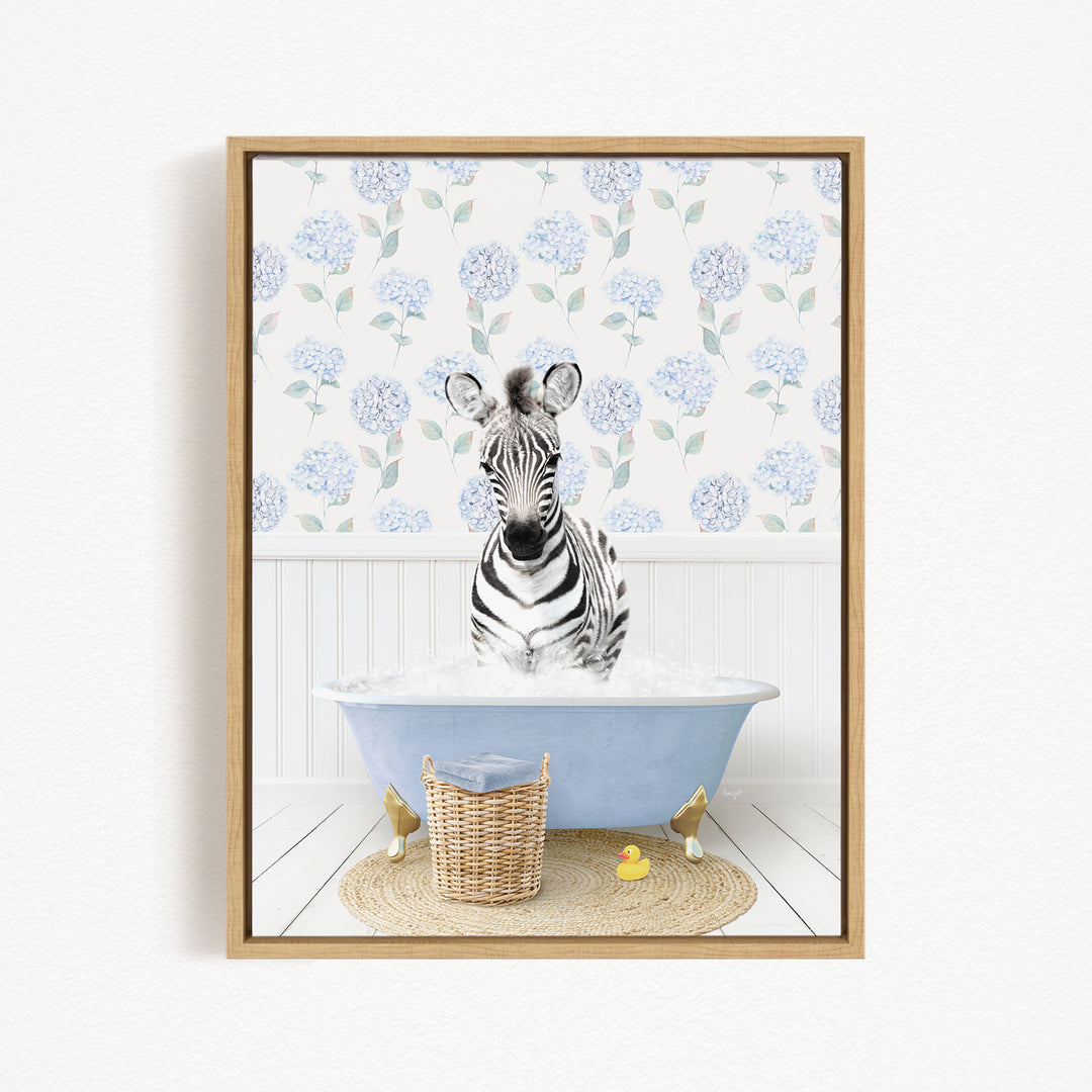 A zebra standing in a blue bathtub filled with water, surrounded by a wicker basket and rubber duckies.