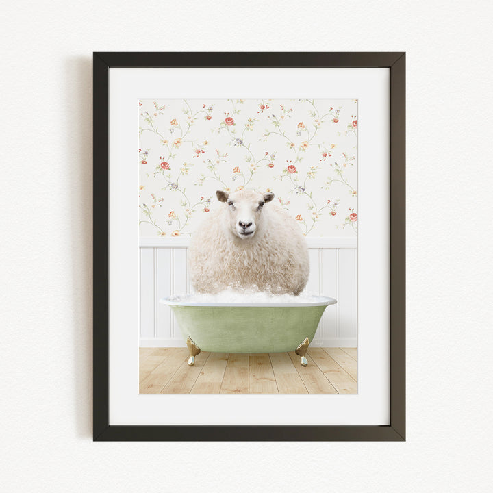 A fluffy white sheep sits in a green bathtub, surrounded by a floral wallpaper.