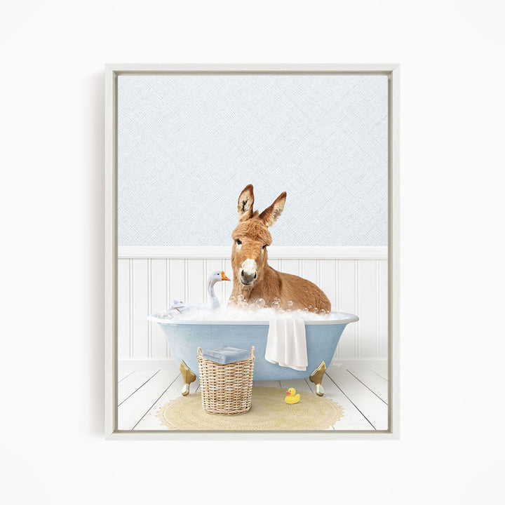 A donkey is sitting in a blue bathtub filled with bubbles, surrounded by various bath toys, including a rubber duck and a goose.
