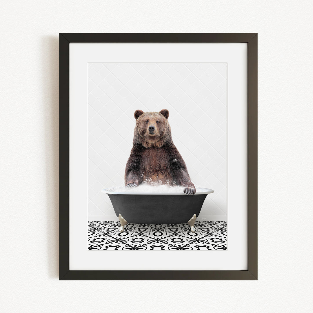 A brown bear sitting in a black bathtub filled with water, surrounded by a black and white patterned floor.