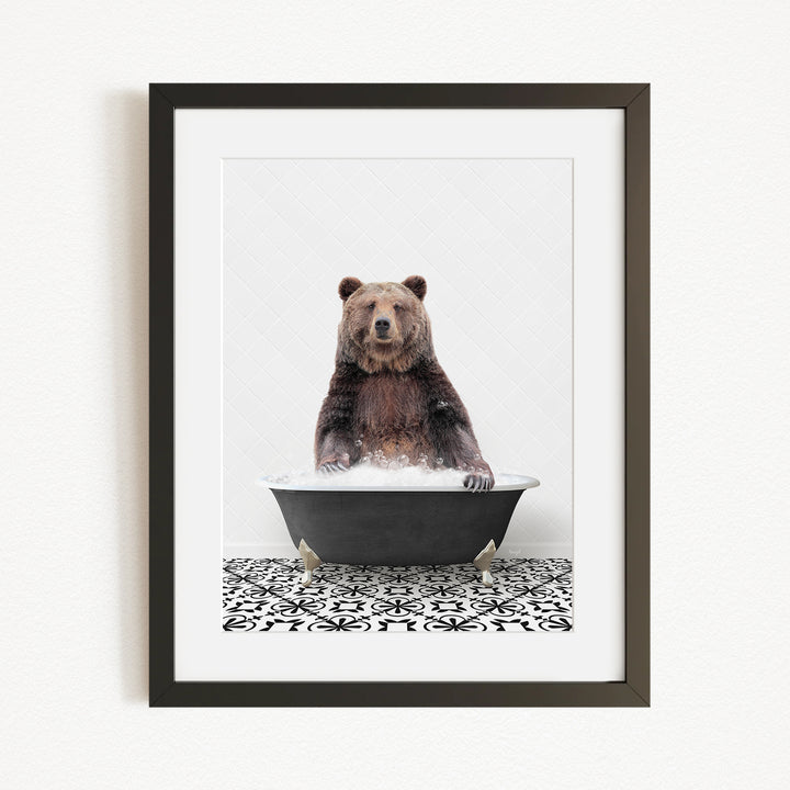 A brown bear sitting in a black bathtub filled with water, surrounded by a black and white patterned floor.