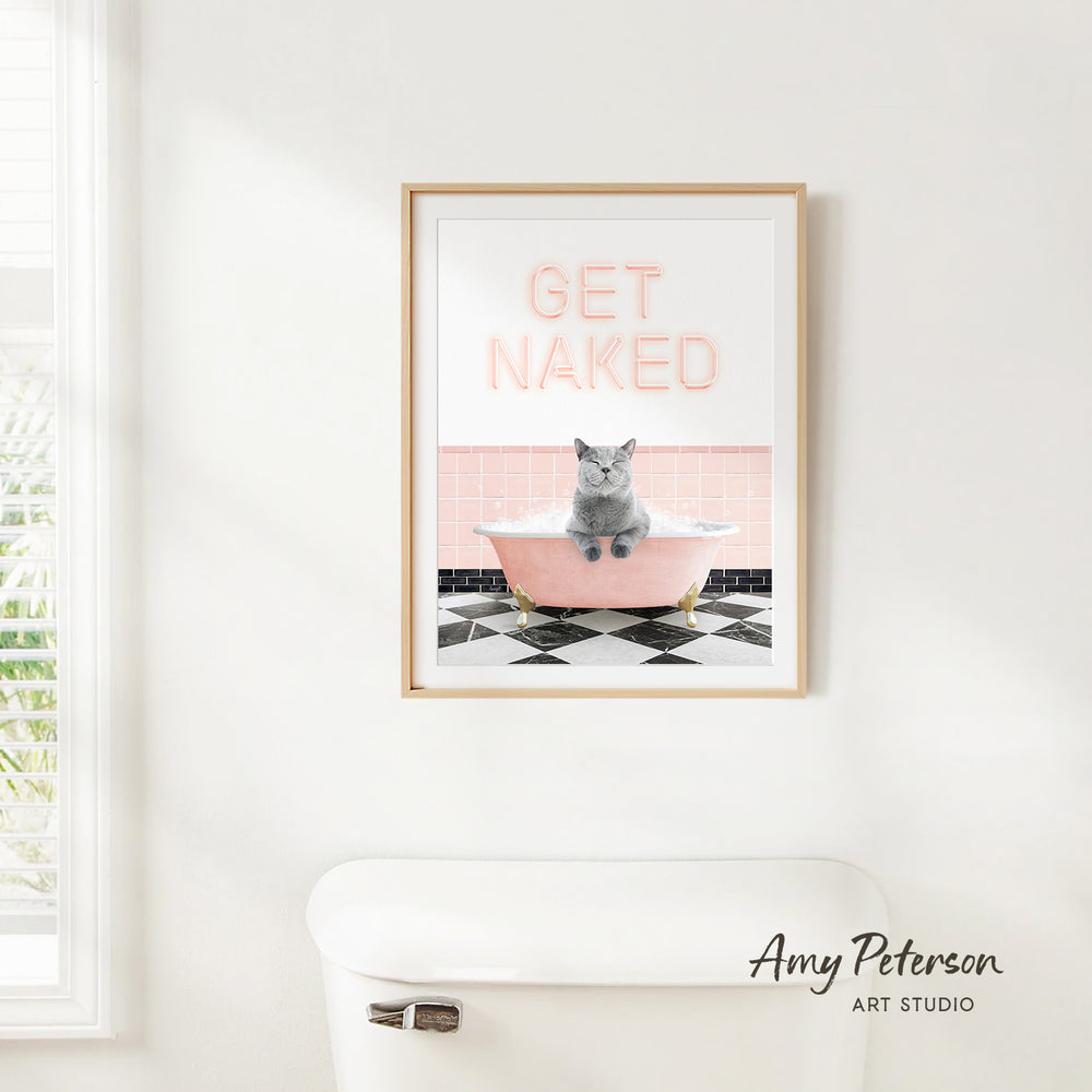 A framed poster with the text "GET NAKED" and an image of a cat sitting in a bathtub.