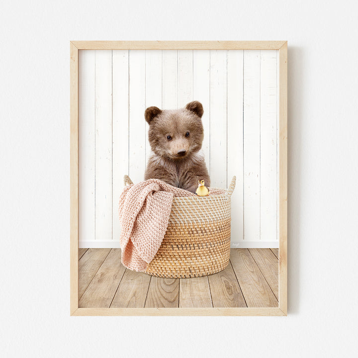 a brown teddy bear sitting in a basket