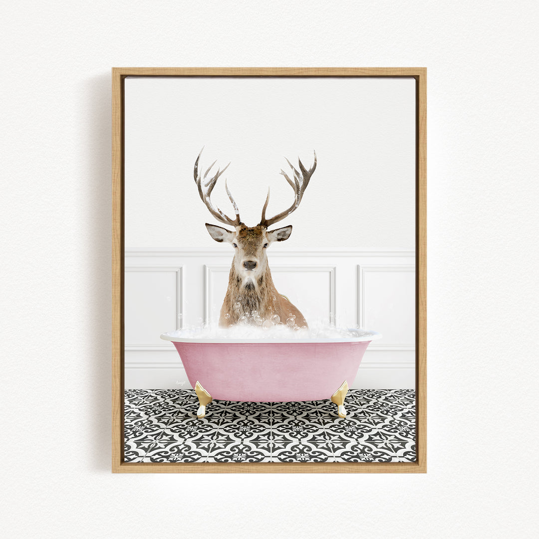 A deer with large antlers is sitting in a pink bathtub filled with bubbles, creating a whimsical and playful scene.