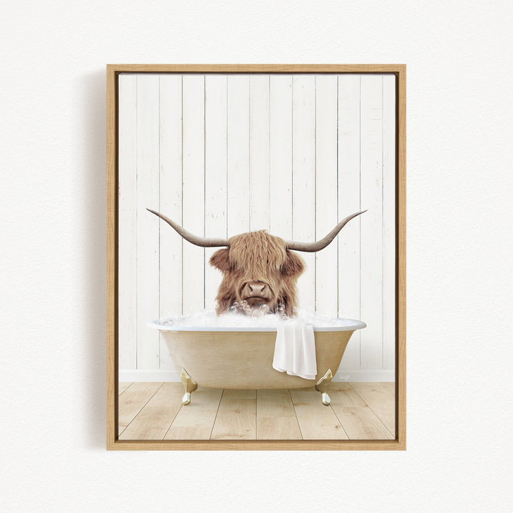 A Highland cow with large horns is sitting in a bathtub filled with water, creating a whimsical and playful scene.