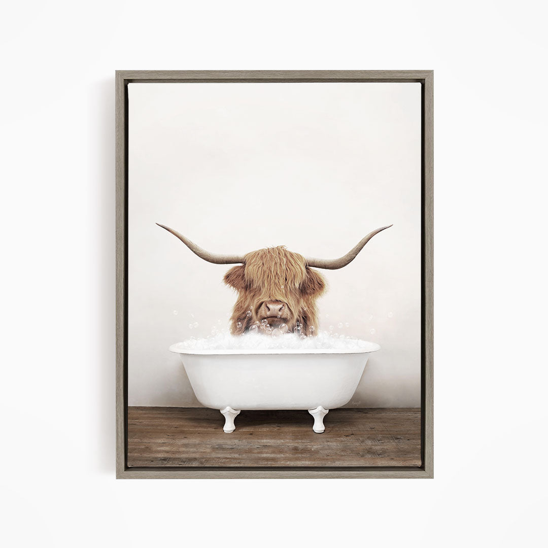 A Highland cow with long horns is sitting in a white bathtub filled with water, creating a whimsical and humorous scene.