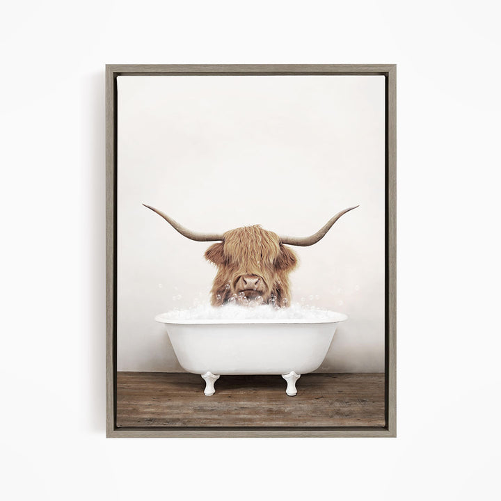 A Highland cow with long horns is sitting in a white bathtub filled with water, creating a whimsical and humorous scene.