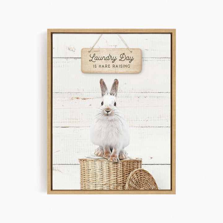 A white rabbit sitting on a wicker basket, with a wooden sign above that says "Laundry Day is Rare Raising".