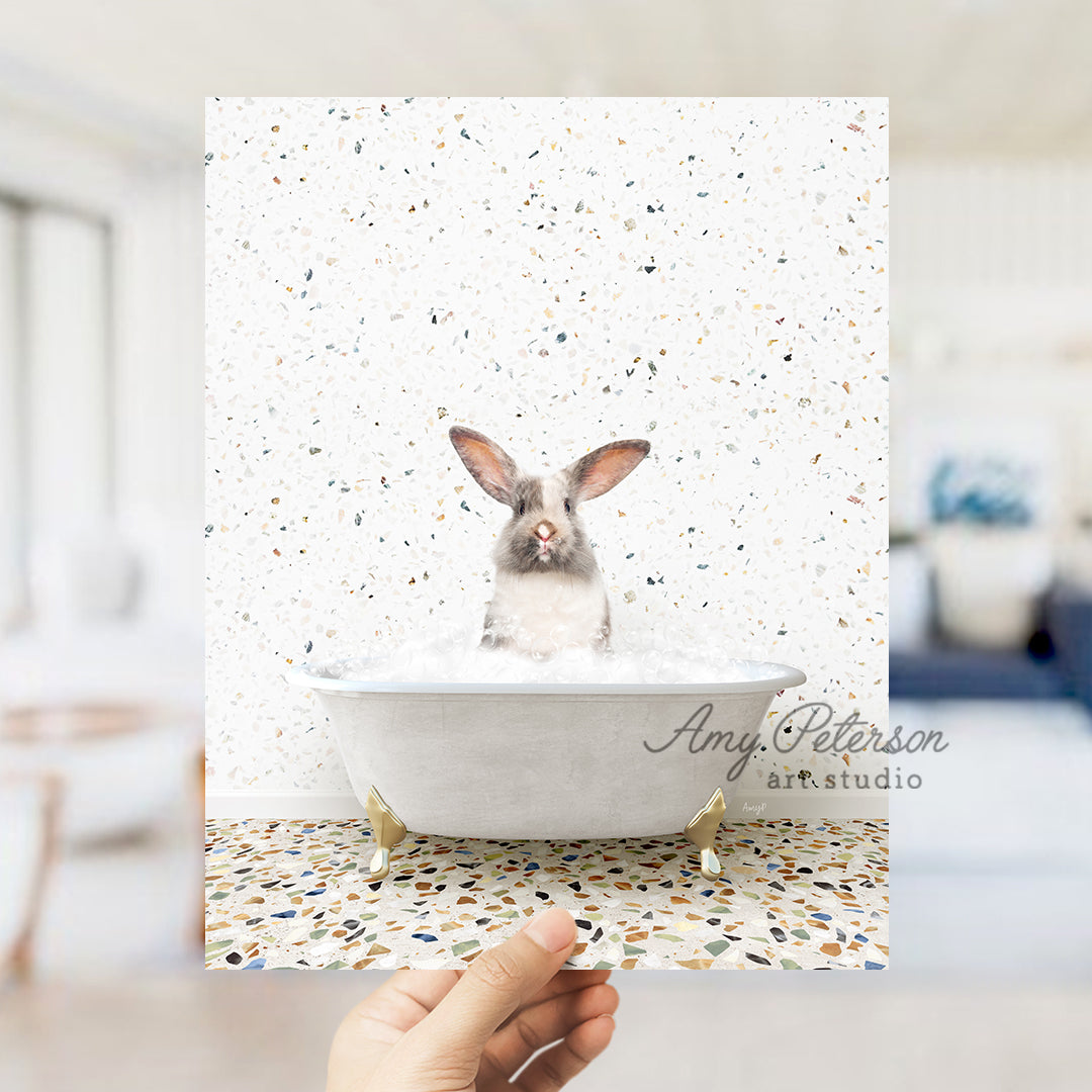 a person holding up a card with a picture of a rabbit in a bathtub