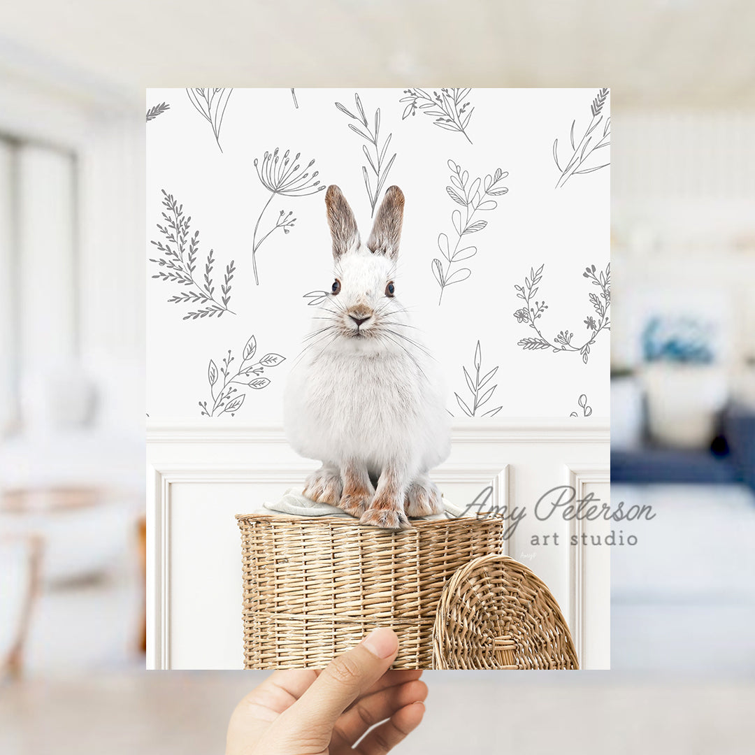 a person holding up a card with a picture of a rabbit on it