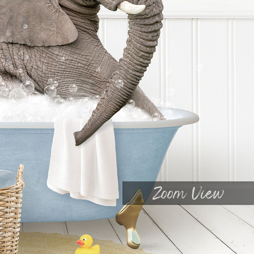 A large gray elephant is sitting in a blue bathtub filled with bubbles, surrounded by a yellow rubber duck and a basket.