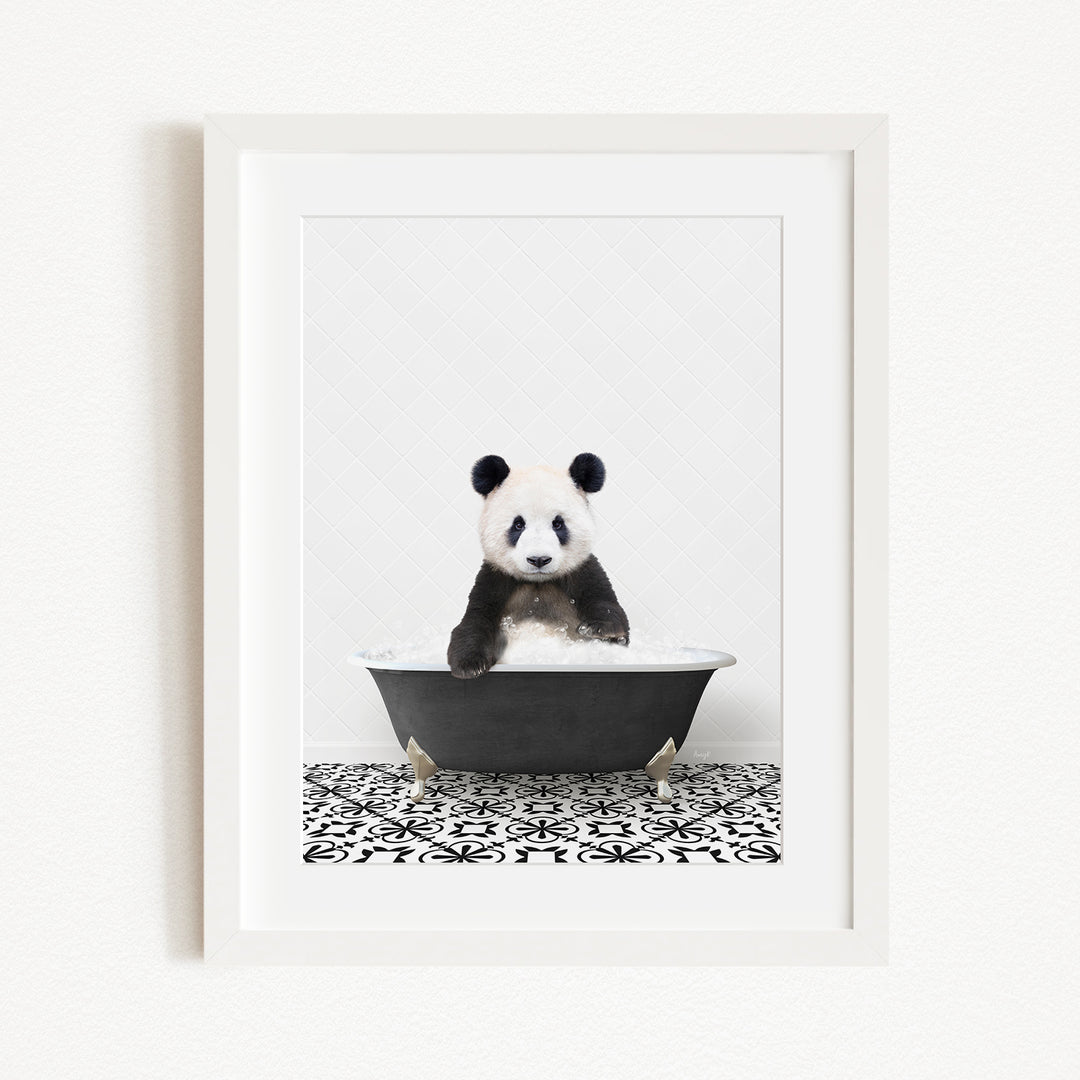 A panda bear sitting in a bathtub, surrounded by a black and white patterned floor.