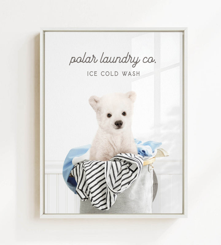 A white polar bear sitting in a laundry basket filled with clothes, with the text "ice cold wash" above the image.