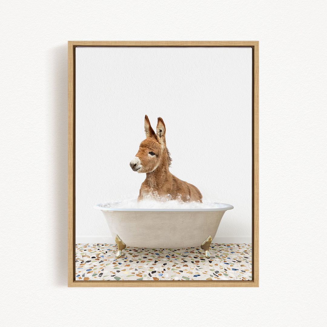 A donkey is sitting in a white bathtub filled with water, creating a playful and whimsical scene.