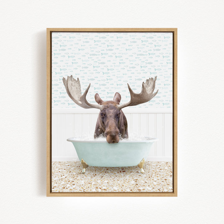 A moose with large antlers is sitting in a bathtub filled with water, creating a whimsical and humorous scene.
