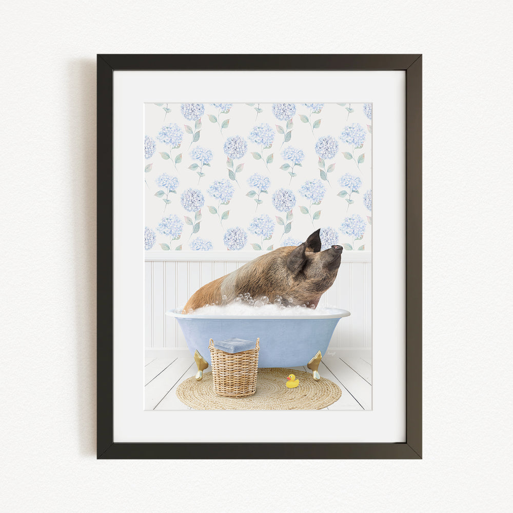 A brown dog is sitting in a blue bathtub filled with bubbles, surrounded by a floral patterned wall and a basket of rubber ducks.