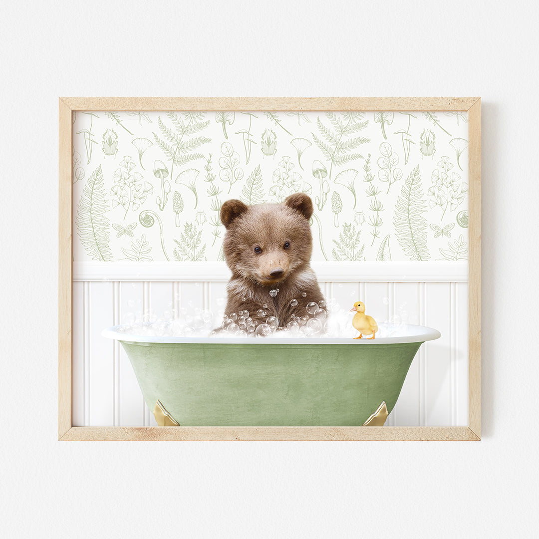 a brown teddy bear sitting in a green bath tub