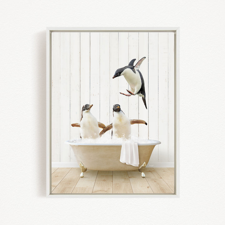 A framed image depicting three penguins in a bathtub, with one penguin flying above the tub.